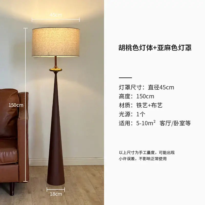 A tall dark brown iron art floor lamp with a textured beige fabric shade from DecorBites led iron collection