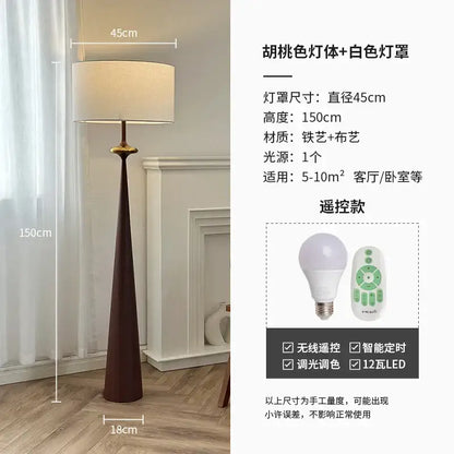 A tall slender floor lamp with dark brown iron base and white shade by decorbites led iron art for living room use