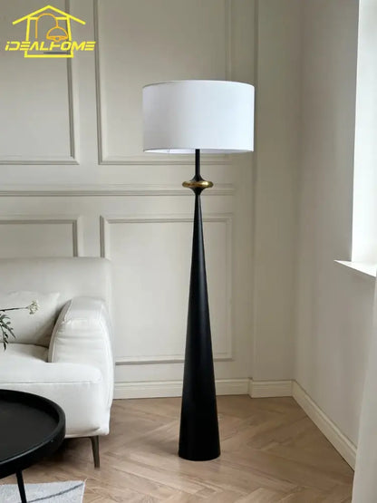 Black tapered floor lamp with white cylindrical shade and gold accent ring from decorbites led iron art collection