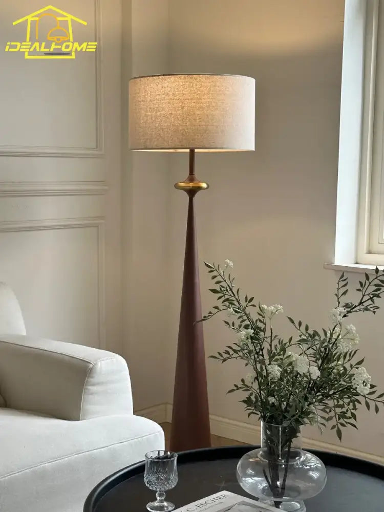 Tall slender decorbites led iron floor lamp with warm beige fabric shade and dark wood base for living room or bedroom