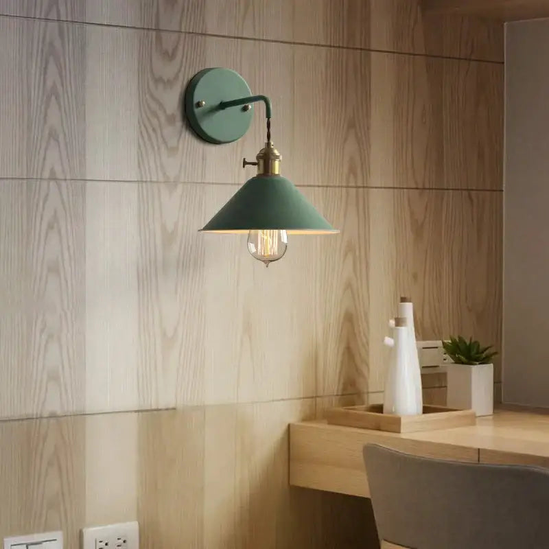 A teal vintage-style decorbites led iron wall light with brass arm and exposed filament bulb for modern decor