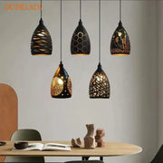 Five black ceramic pendant lights with intricate gold cutouts hang ceiling decorbites led iron cage pendant light