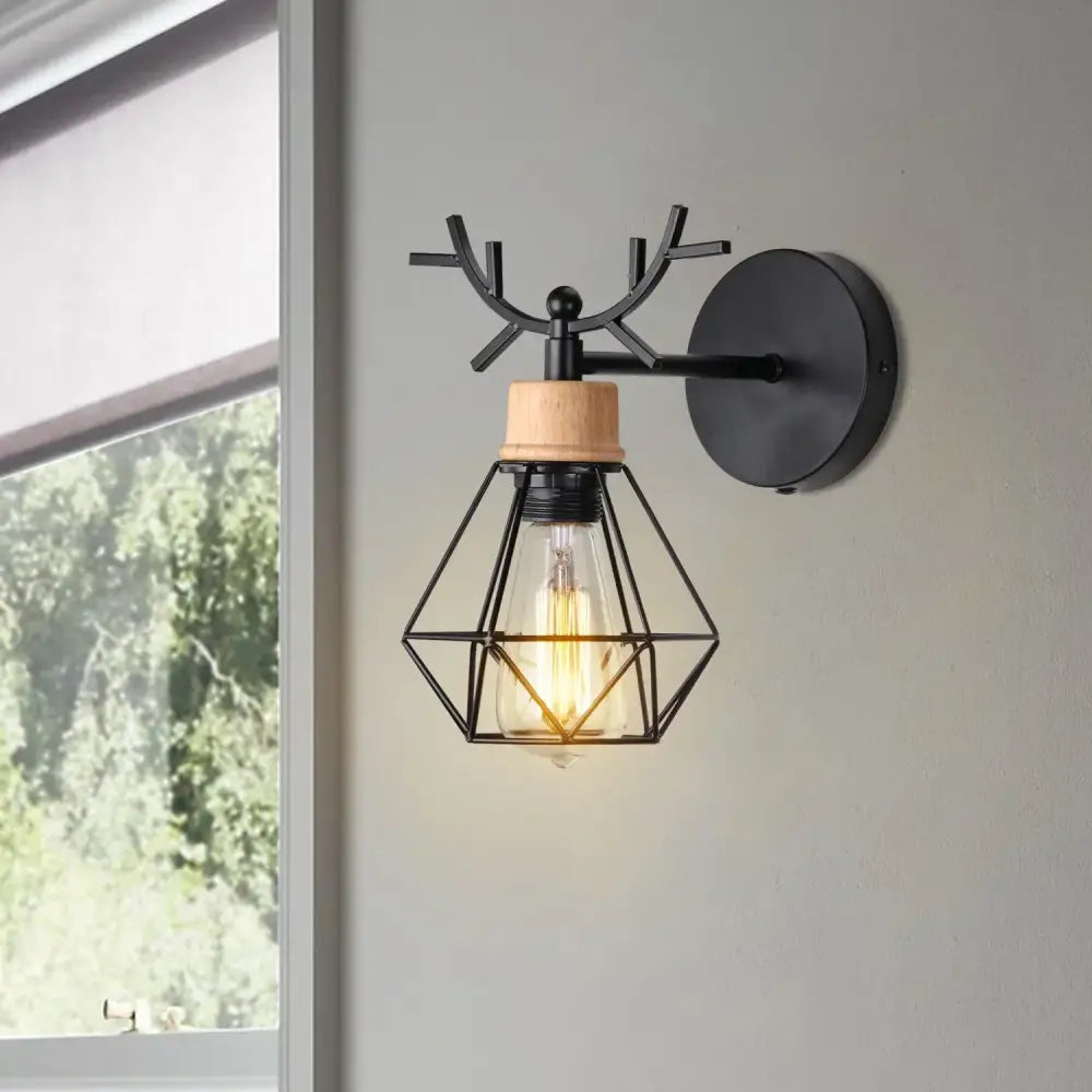 Black metal decorbites led iron wall light with antler top wooden accent and geometric cage housing exposed filament bulb