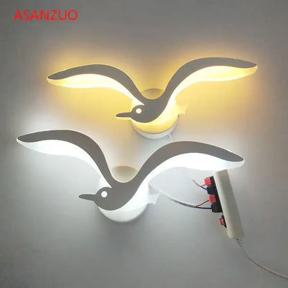Two decorbites led jellyfish wall sconce lamps shaped like seagulls glowing warm yellow and cool white for indoor use