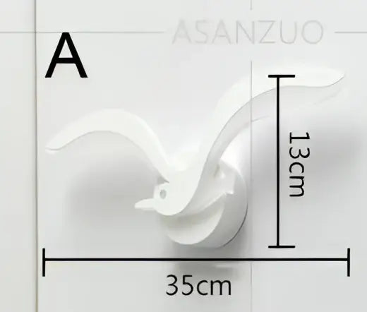 White ceramic wall-mounted bird sculpture 13cm tall 35cm wide paired with decorbites led jellyfish wall sconce light