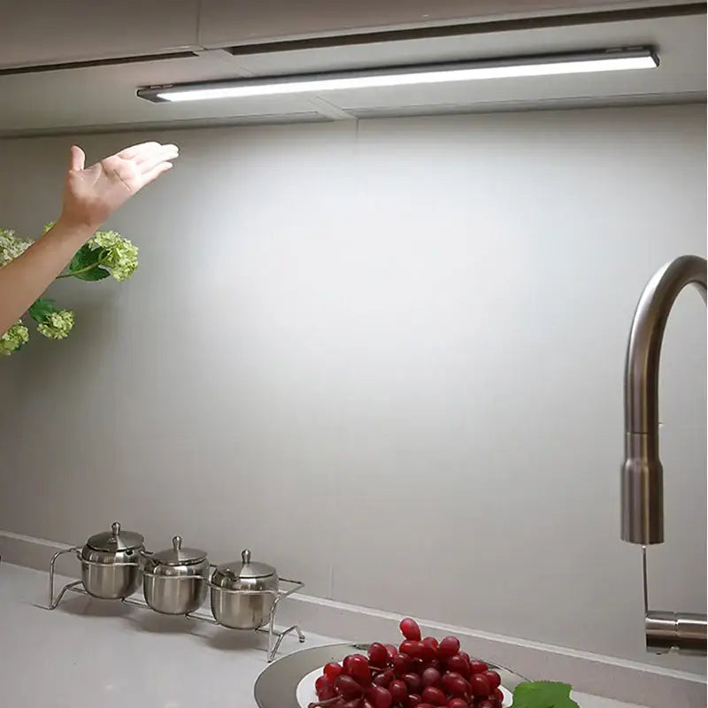 A sleek slim metallic decorbites led kitchen cabinet light with hand sweep sensor and integrated brightness control