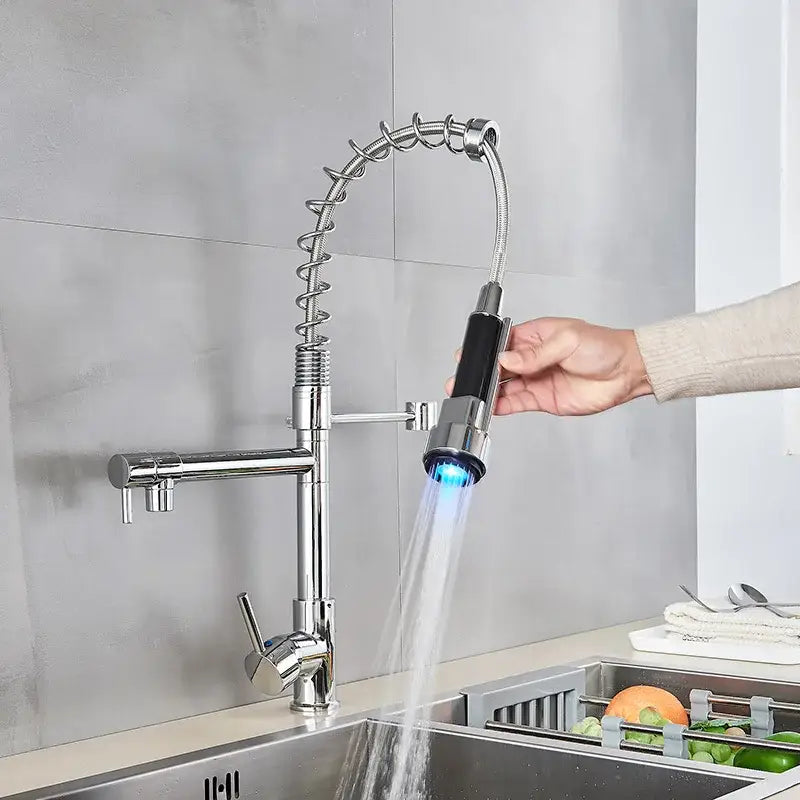 A sleek black brass DecorBites led kitchen faucet with flexible spring spout and blue light pull-down spray head