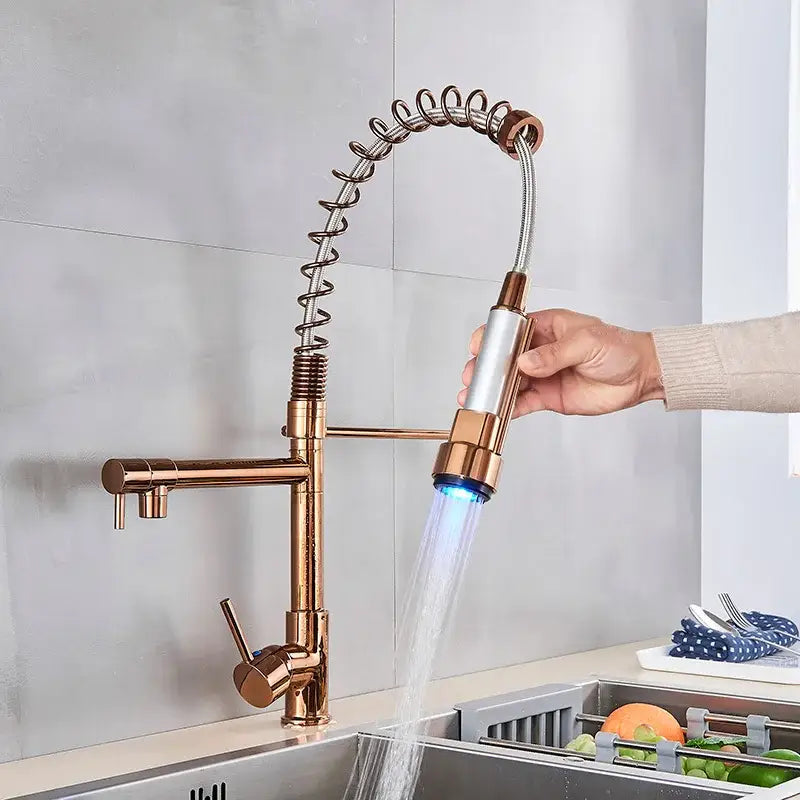 Rose gold brass kitchen faucet with flexible coiled hose and illuminated spray head by DecorBites led kitchen faucet