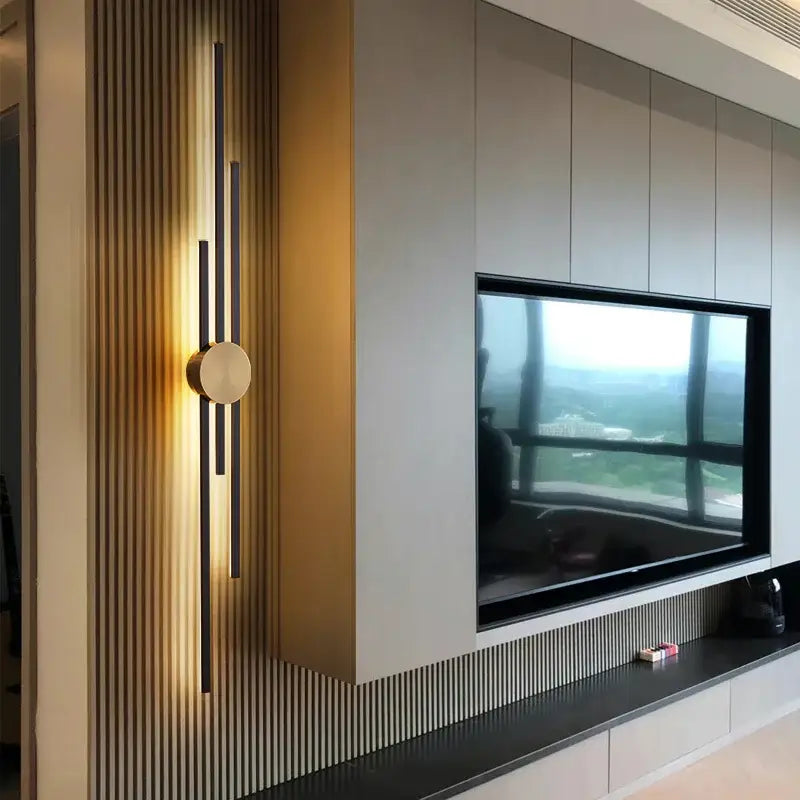 Modern minimalist decorbites led long wall lamp with black rods and gold accent on textured wood wall panel