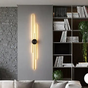 Decorbites led long wall lamp with slender gold-toned bars and black base emitting warm light for living spaces