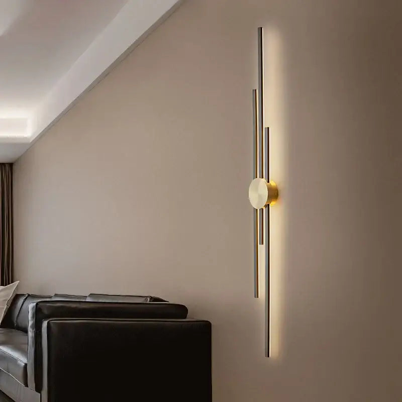Modern gold-toned decorbites led long wall lamp with slender vertical rods and circular light for living room and staircase