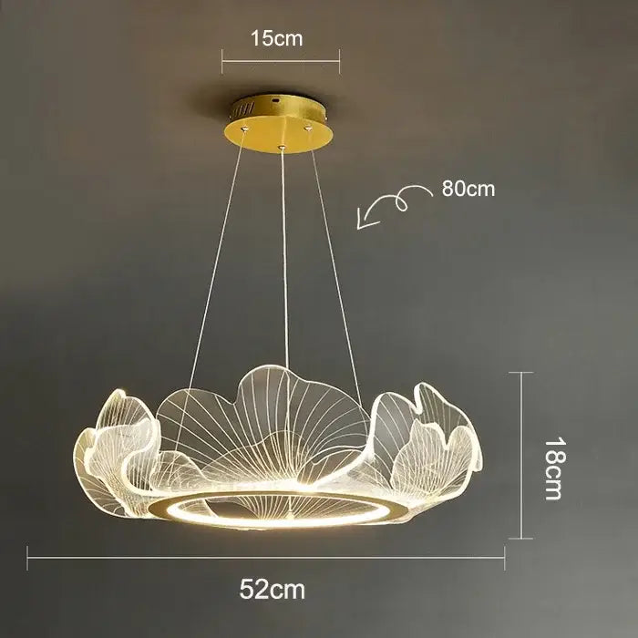 A modern gold-toned decorbites led lotus leaf pendant light with translucent leaf design and illuminated circular base