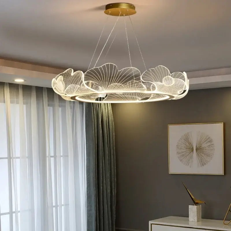 A decorbites led lotus leaf ceiling chandelier with gold base and white wireframe petals emitting soft light