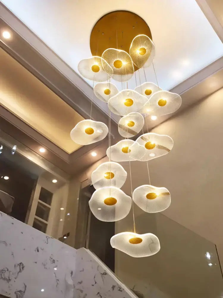 A decorbites led lotus staircase chandelier with translucent white egg-shaped lights and gold centers for modern lighting