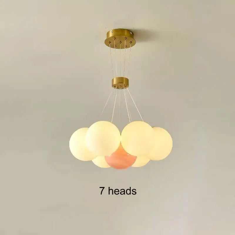 Gold-finished DecorBites LED Lunar ceiling chandelier with seven frosted glass orbs for elegant home decor lighting
