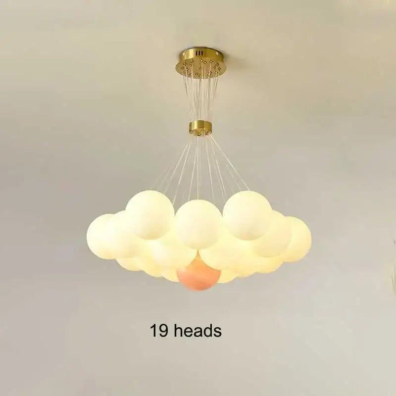 A modern decorbites led lunar cloud-shaped pendant light with 19 frosted glass orbs and gold metal fixture