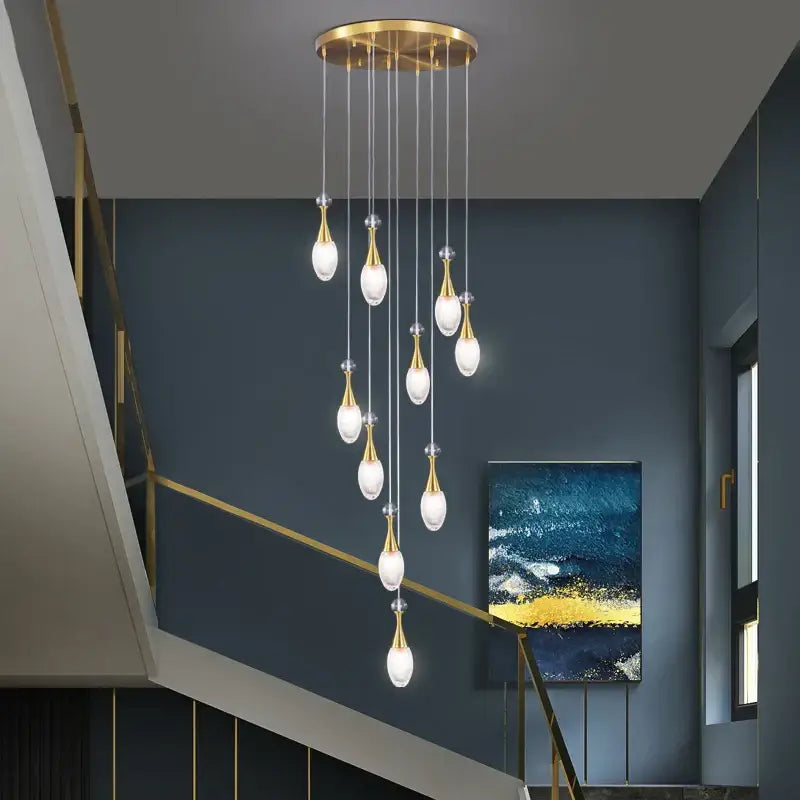 Gold-toned decorbites led luxury chandelier with teardrop glass bulbs hanging from brass fixture for living room lighting