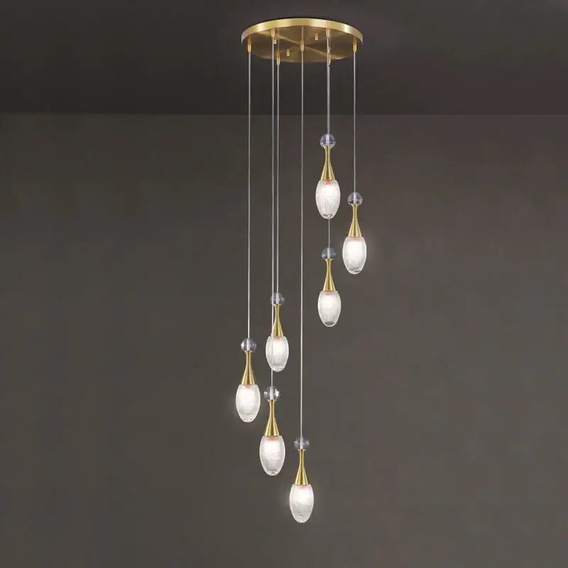 Gold-toned decorbites led luxury chandelier with six teardrop glass shades suspended from circular brass fixture