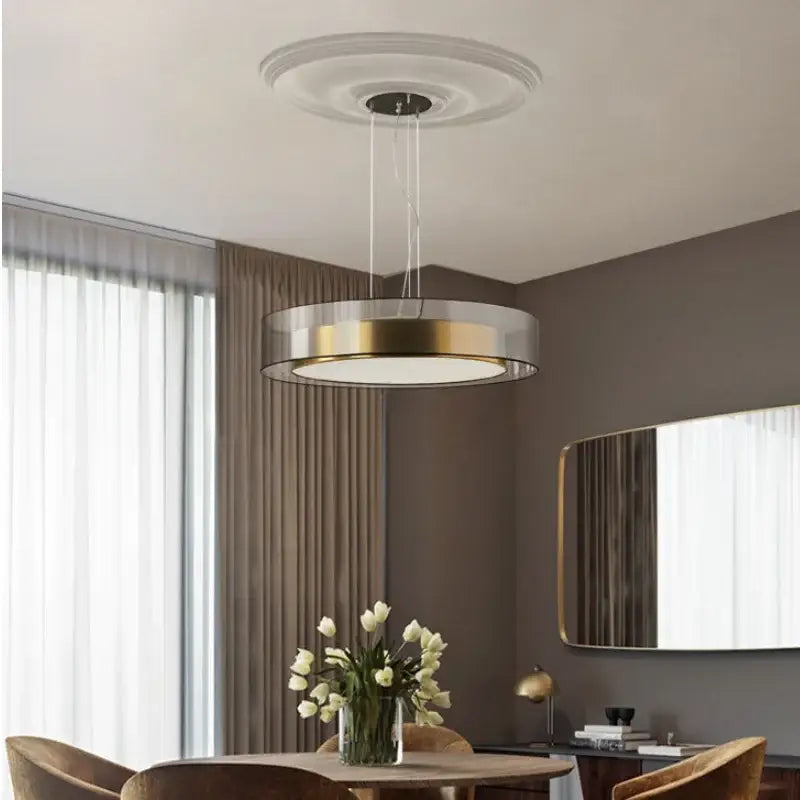 Modern circular DecorBites LED luxury chandelier with gold and clear glass design for minimalist master bedroom decor