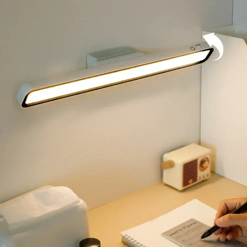 Modern white DecorBites LED magnetic desk lamp with sleek minimalist design and black trim for cabinet and table use