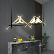 Gold-toned decorbites led magpie pendant light featuring a sleek modern bird design for living and dining room decor