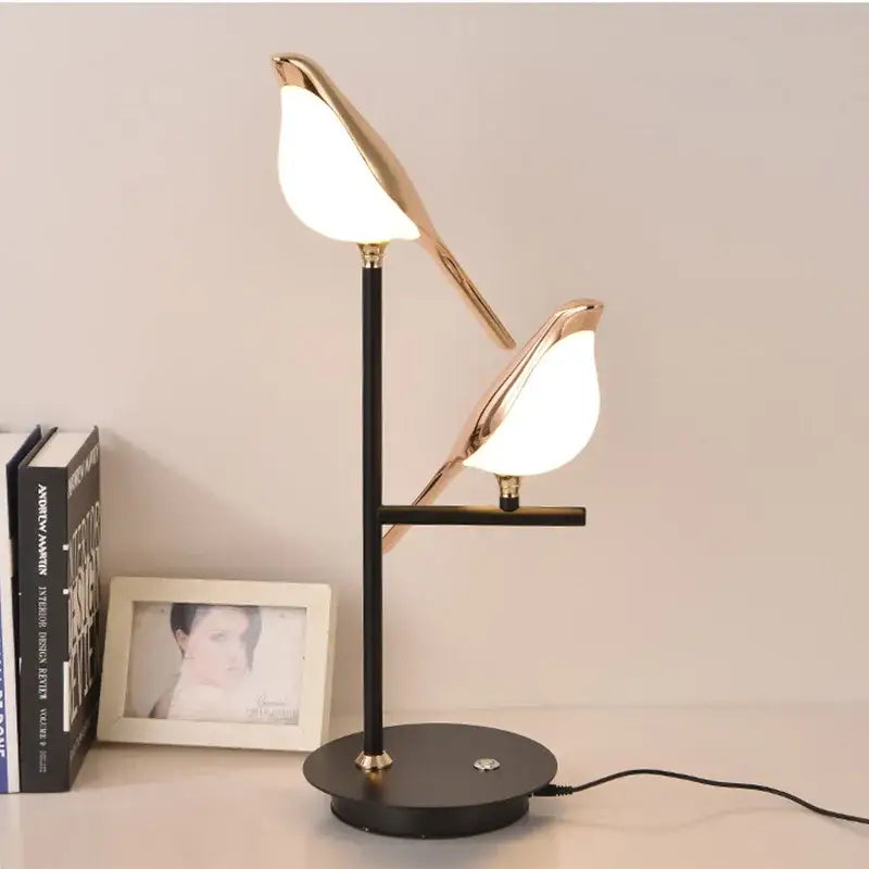 Gold-toned led magpie bird pendant light with pearlescent white shades and black metal base by DecorBites for modern decor