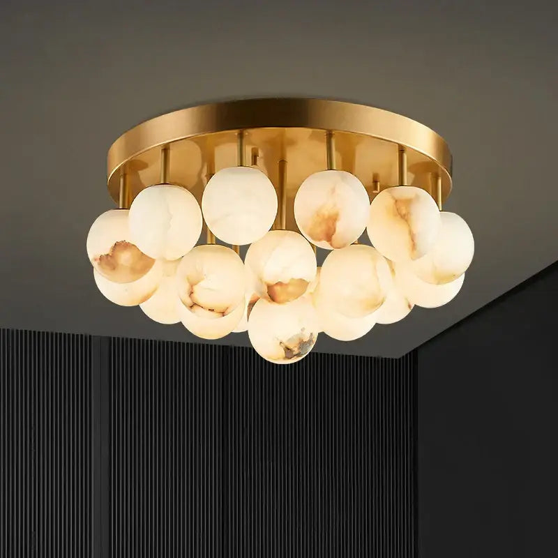 Gold-toned decorbites led marble balls chandelier with translucent white and beige onyx orbs for dining room lighting