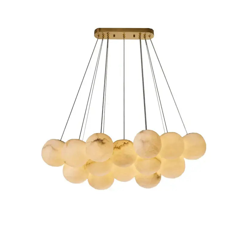 A modern decorbites led marble balls chandelier with brass mount and translucent opalite globes for dining room