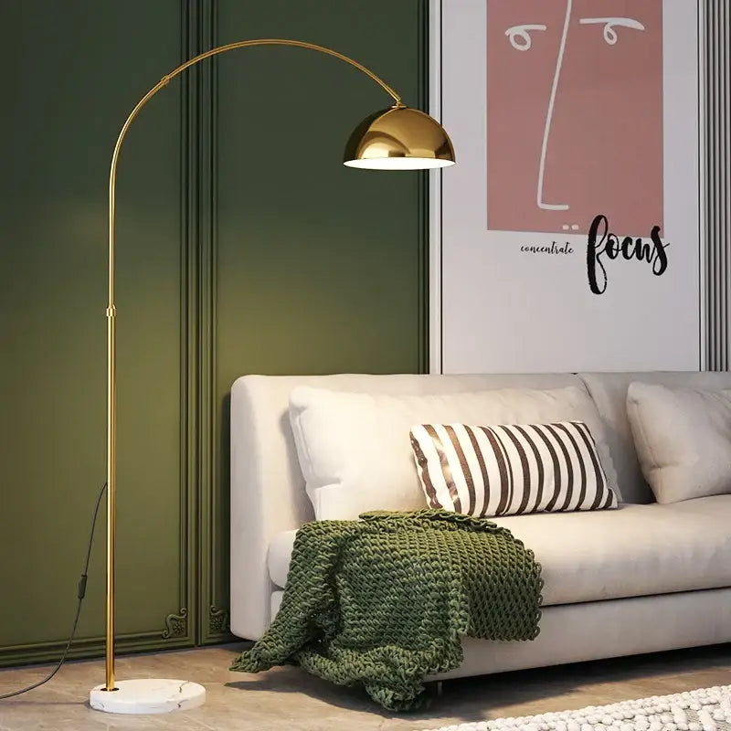 Gold-toned decorbites led marble floor lamp with arched design, dome shade, and white marble base for modern living rooms