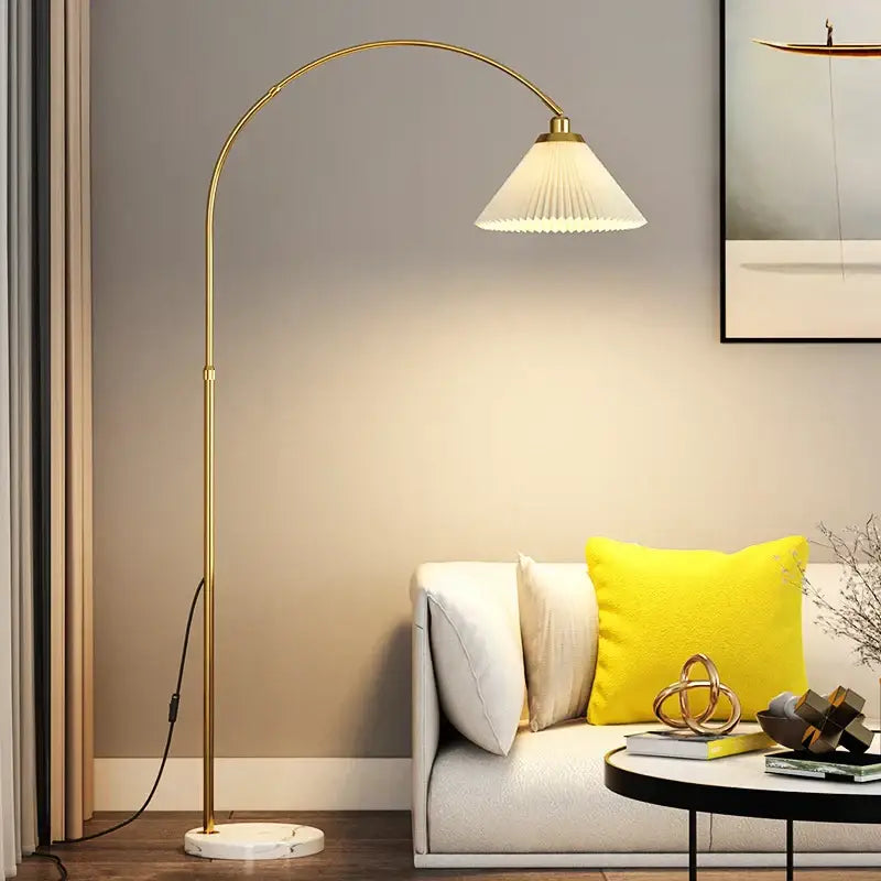 Gold-toned DecorBites LED marble base floor lamp with arched design, white pleated shade for modern living room lighting