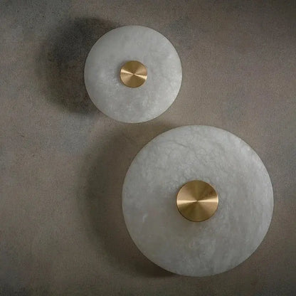 Two circular white marble decorbites led marble brass wall sconces with polished centers for parlor and aisle lighting