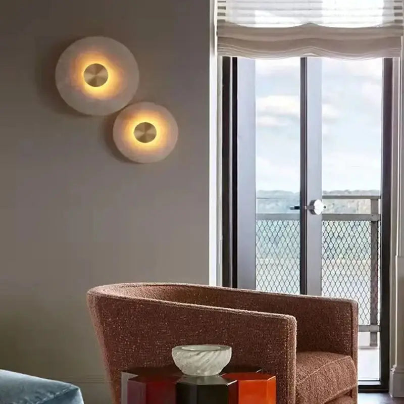 Two DecorBites™ LED marble brass wall sconces with frosted glass shades and warm glow for parlor and aisle lighting