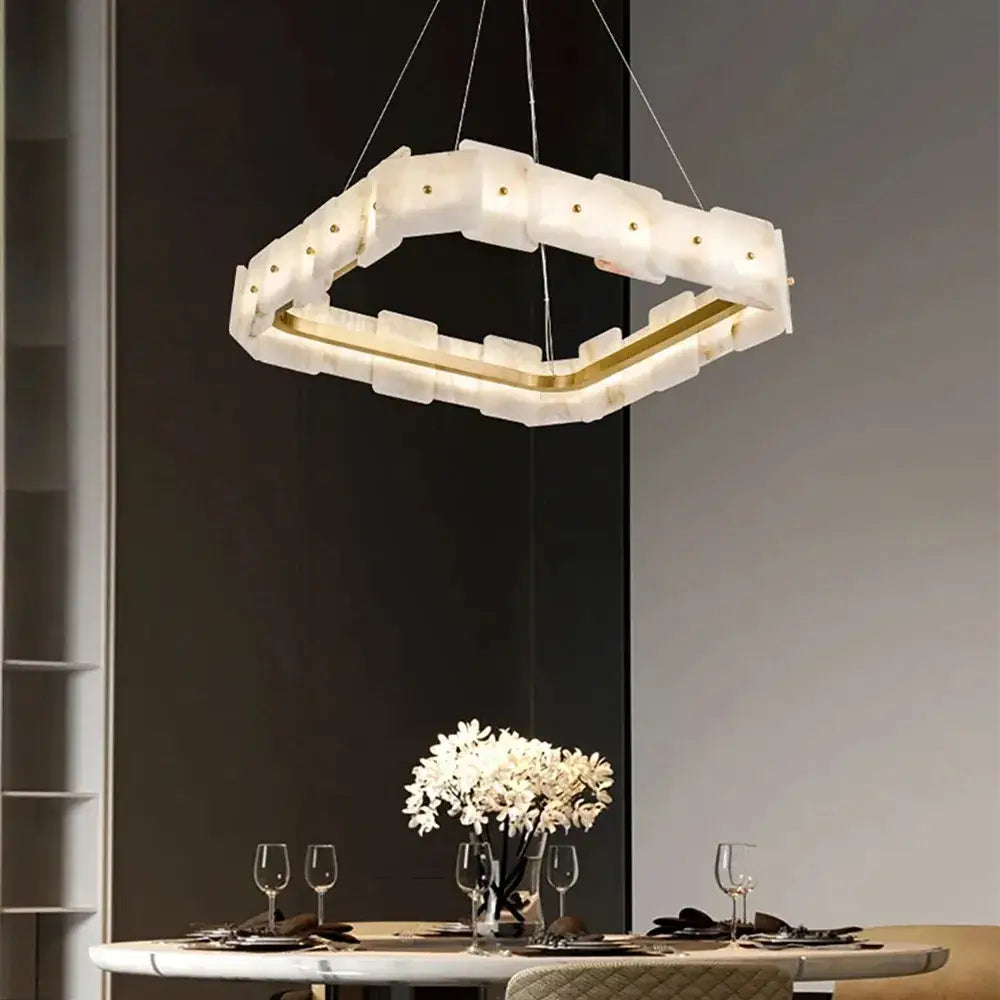 A modern decorbites led marble chandelier with a white translucent acrylic body and gold-toned accents for elegant lighting