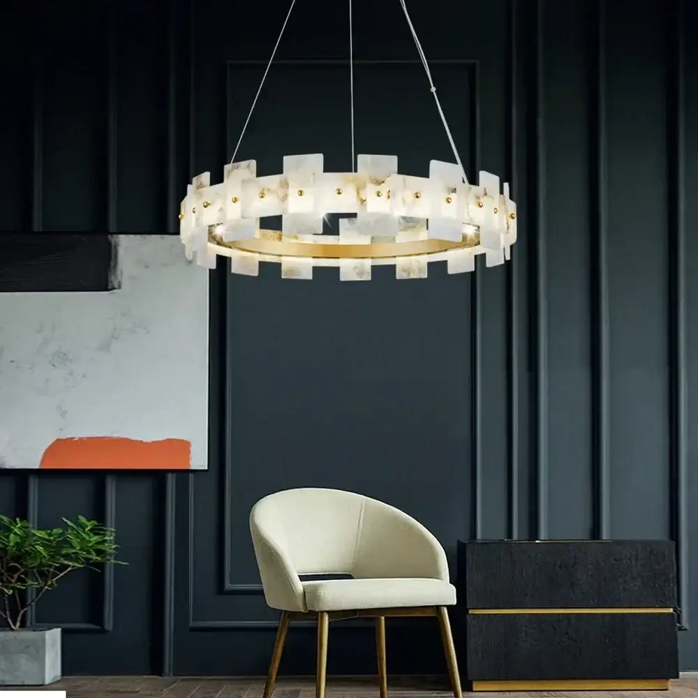 A modern circular decorbites led marble chandelier with white marble-like panels and gold-toned accents for living rooms