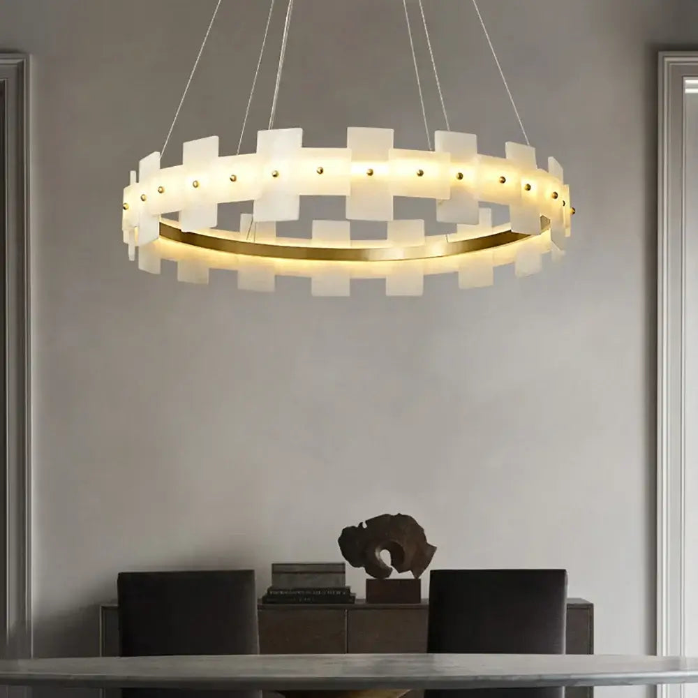 Modern circular decorbites led marble chandelier with frosted white panels and gold ring illuminated by warm led lights