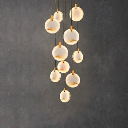 Modern chandelier with translucent white opal discs and gold-toned hardware decorbites led marble gold chandelier