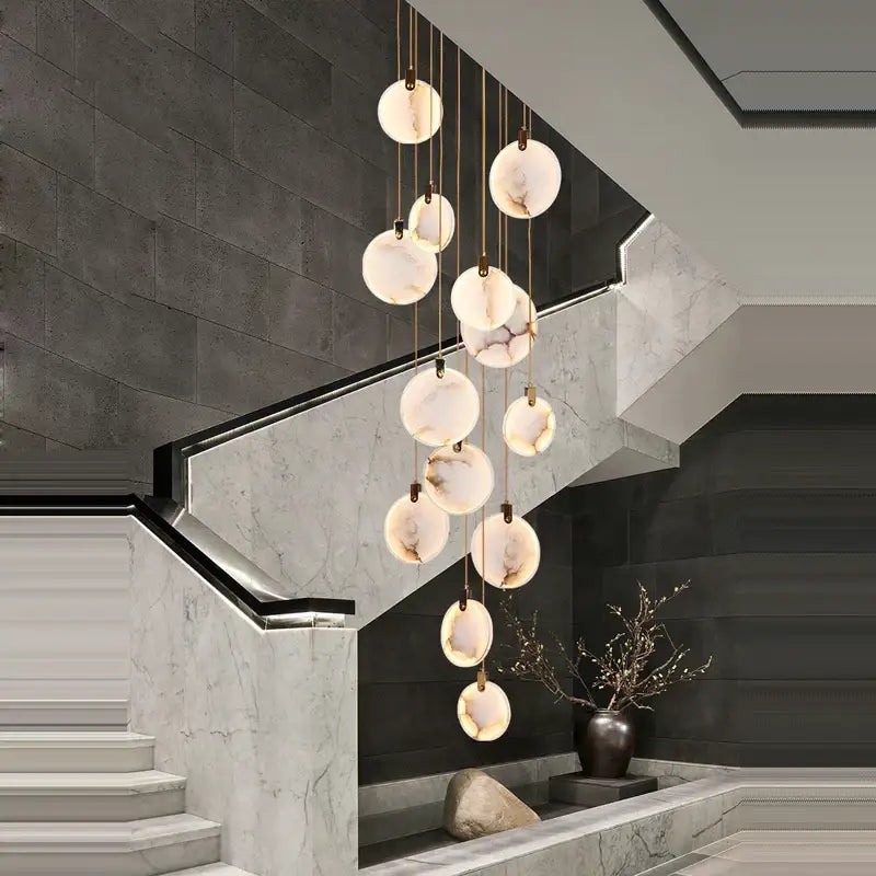 A decorbites led marble gold chandelier with spherical translucent marble-like shades suspended by thin metallic chains