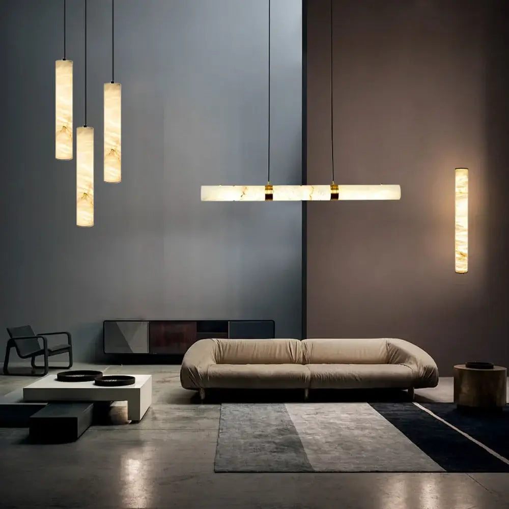 Beige upholstered sofa with modern design and low-profile legs displayed alongside decorbites led marble hanging lamps white alabaster