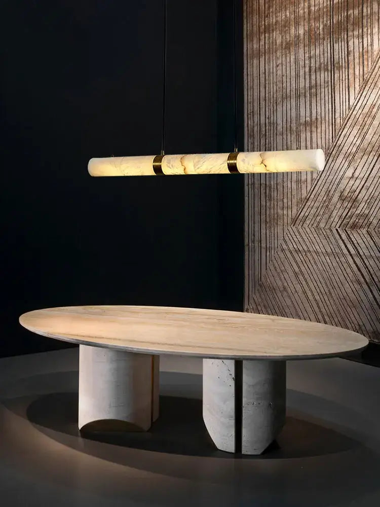 Modern oval dining table with light wood top and sleek concrete legs paired with DecorBites™ led marble white alabaster hanging lamps