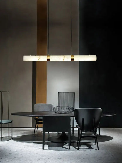 DecorBites™ led marble hanging lamps in white alabaster with gold accents above a dining table