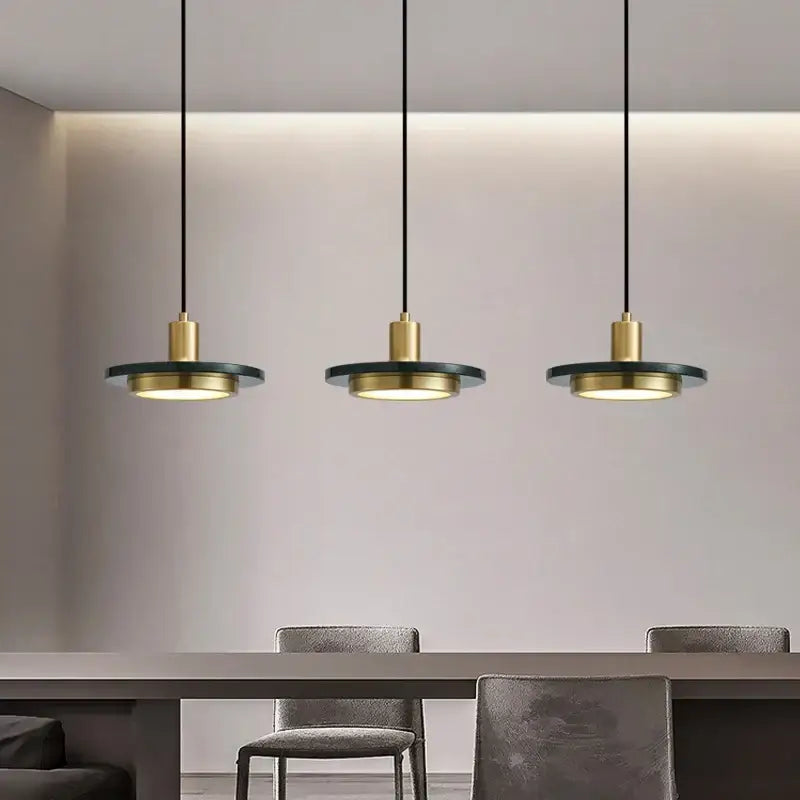 Three modern decorbites led marble pendant lamps with gold fixtures dark green shades and warm glow for home and restaurant