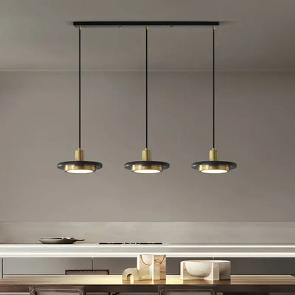 Modern black and brass decorbites led marble pendant lamp with circular shades hanging from a sleek bar