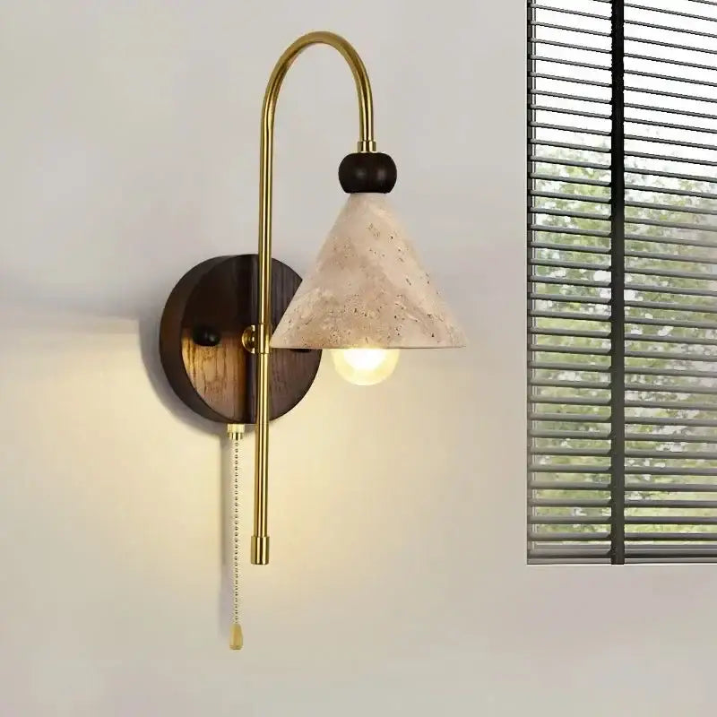 Brass-finished decorbites led marble wall light with dark wood backplate and textured stone conical shade for indoor use