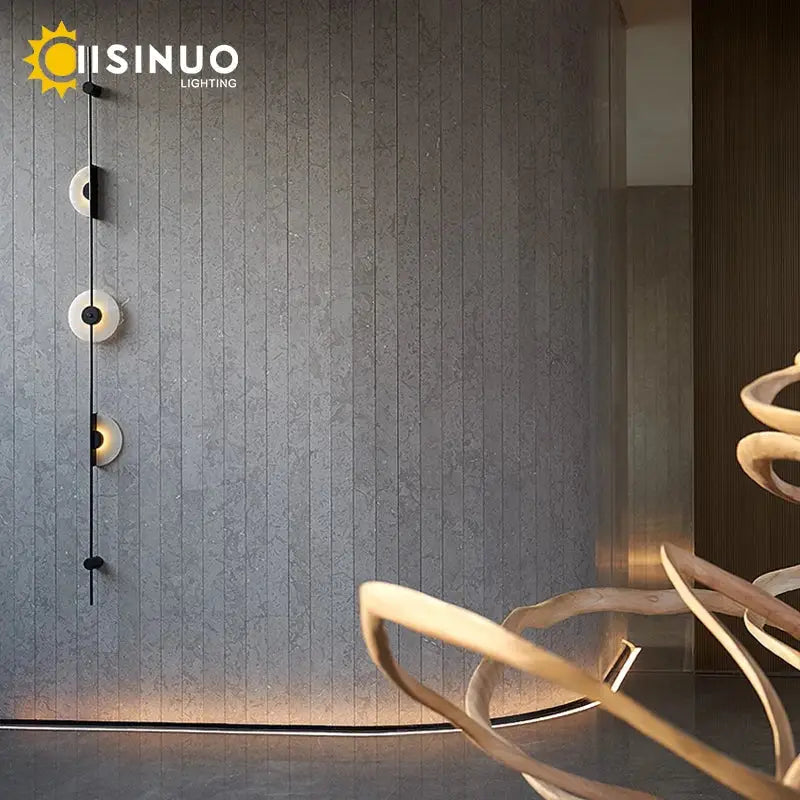 Modern minimalist DecorBites led marble wall lights with three frosted glass shades on black metal for living room use