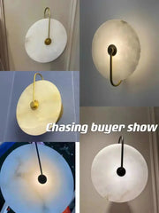 Decorbites led marble wall sconce featuring a frosted white marble disc with a slender brass arm for living room decor