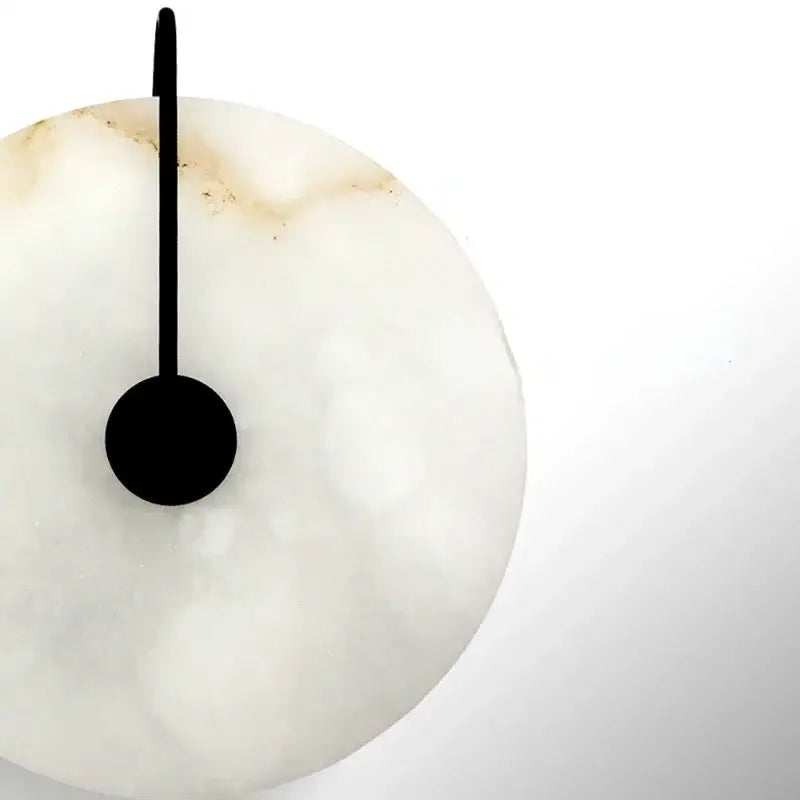 Minimalist white onyx wall clock with sleek black hand and circular base in decorbites led marble wall sconce design
