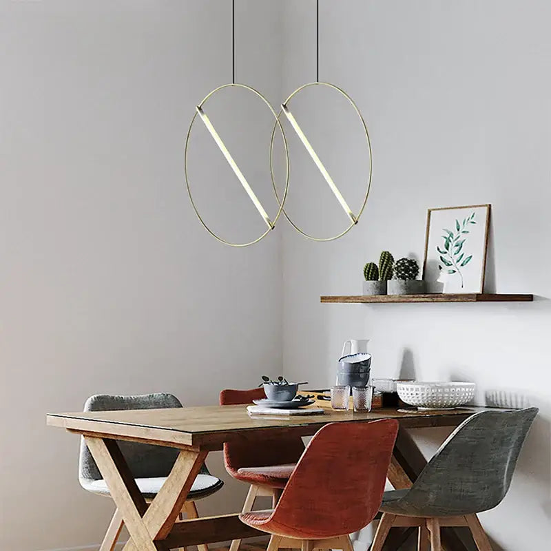Modern gold-toned decorbites led metal pendant light with circular minimalist design for dining room and bedroom use