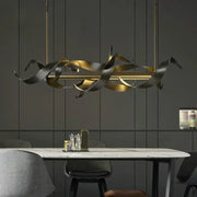 A modern decorbites led metal pendant light with flowing gold and dark bronze metallic ribbons for elegant decor