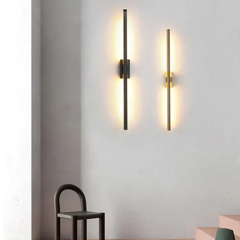 Two modern minimalist wall lamps by decorbites led metal tube in matte black and brushed gold with warm lighting