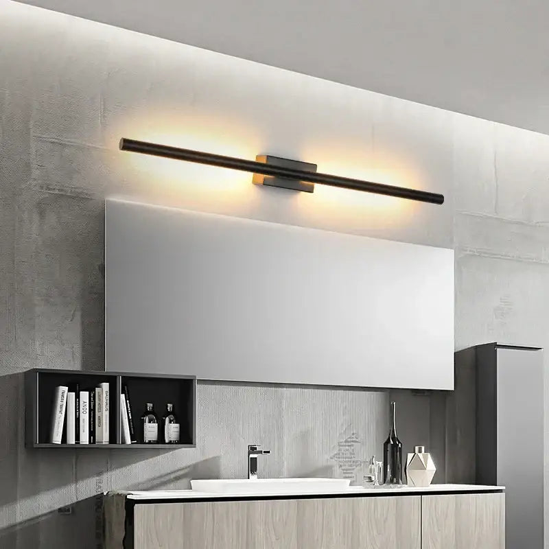 Modern black decorbites led metal tube wall lamp with warm led illumination above a bathroom mirror